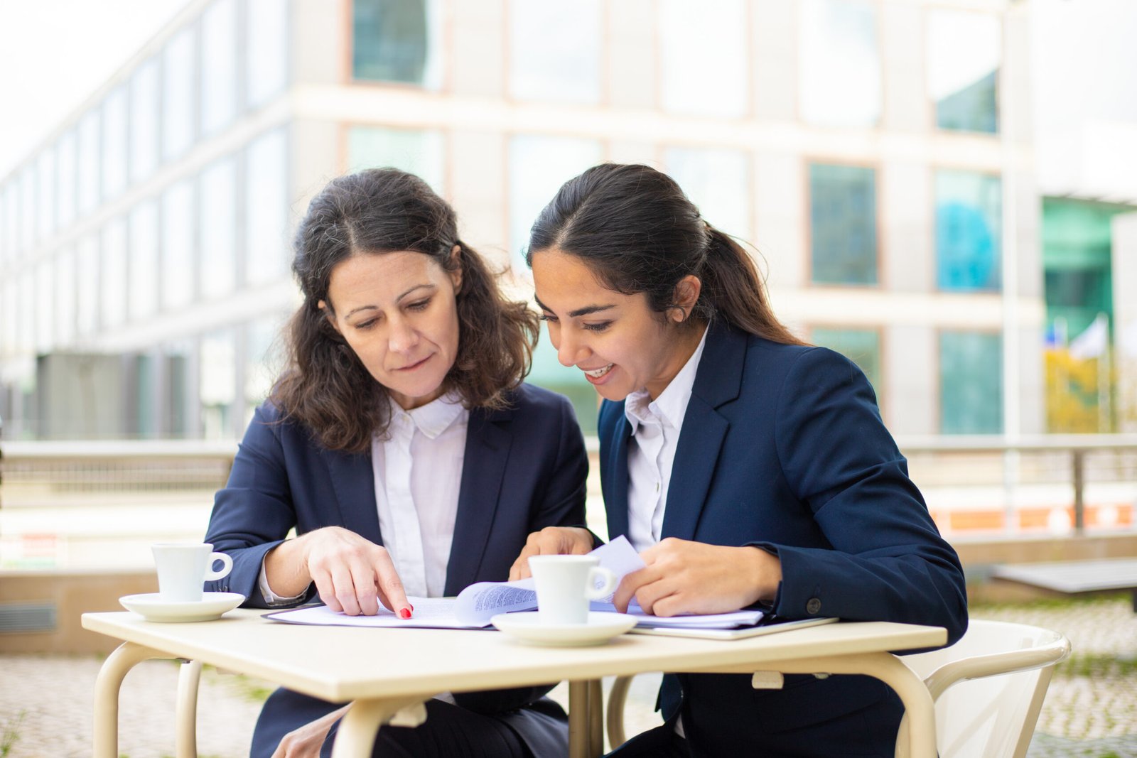 Businesswomen working with documents in outdoor cafe